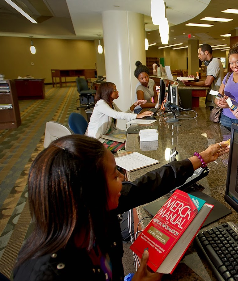 Librarians assisting students in the front lobby of the University Library